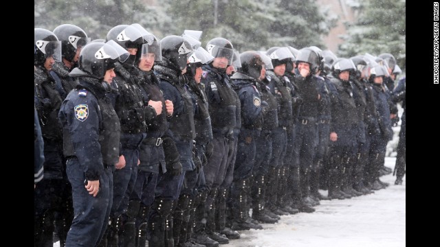 Policemen stand guard outside the regional state administration building in Donetsk, Ukraine, during a rally by pro-Russia activists March 17.