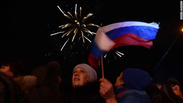 Crimeans holding Russian flags celebrate in front of the parliament building in Simferopol on Sunday, March 16.