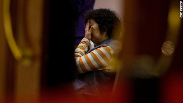 A relative of missing passengers waits for a news briefing by officials in Beijing on Tuesday, March 18.