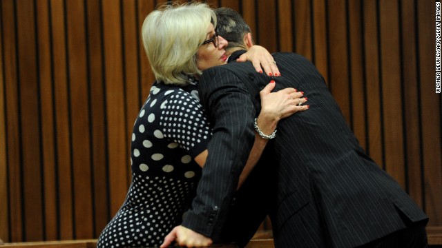 Pistorius is hugged by his aunt Lois on March 18.