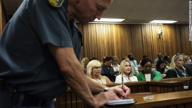 Steenkamp's mother, wearing the white collared shirt, looks on while a police officer takes notes in court March 18.