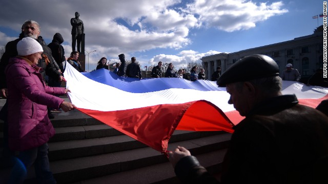 Demonstrators hold a Crimean flag at Lenin Square in Simferopol on March 18.