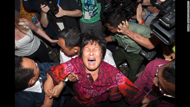 A distraught relative of a missing passenger breaks down while talking to reporters at Kuala Lumpur International Airport on Wednesday, March 19.