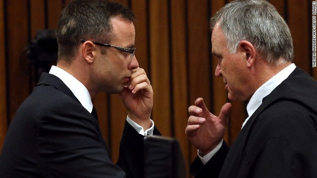 Oscar Pistorius, left, speaks with his lawyer, Barry Roux, in a Pretoria, South Africa, courtroom on Wednesday, March 19. Pistorius, the first double amputee runner to compete in the Olympics, is accused of intentionally killing his girlfriend, Reeva Steenkamp, in February 2013. Pistorius has pleaded not guilty to murder and three other weapons charges.
