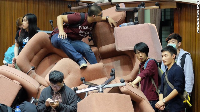 Protesters use chairs to block the entrance to the Legislature.