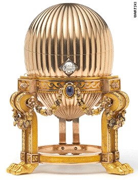 The 8.2-centimeter (3.2-inch) Faberge egg is on an elaborate gold stand supported by lion paw feet. Three sapphires suspend golden garlands around it, and a diamond acts as an opening mechanism.