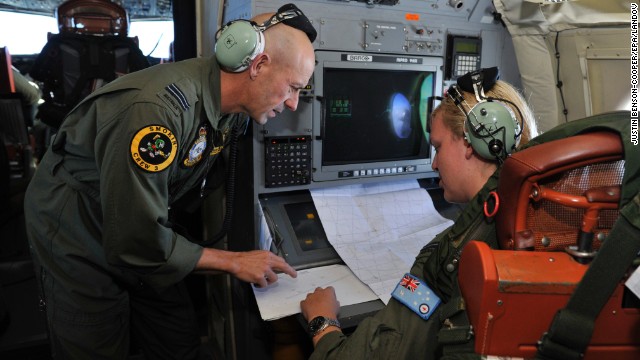 The Royal Australian Air Force's Neville Dawson, left, goes over the search area with Brittany Sharpe aboard an AP-3C Orion some 2,500 kilometers (about 1,500 miles) southwest of Perth, Australia, over the Indian Ocean on March 21.