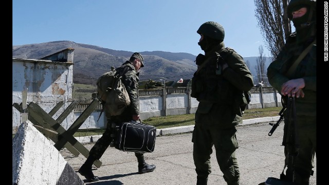 A Ukrainian serviceman leaves a Ukrainian military unit that Russian soldiers took control of in the Crimean city of Perevalne on March 21.