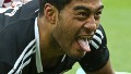 Akira Ioane of New Zealand scores a try under pressure from England's Tom Mitchell during the IRB Sevens World Series cup semi final match in Wellington, New Zealand.