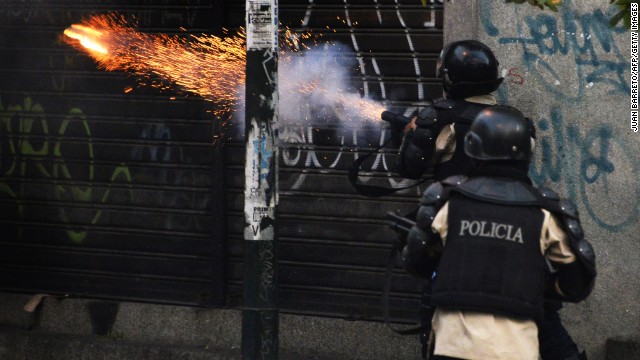Riot police shoot tear gas during the March 22 protest. 