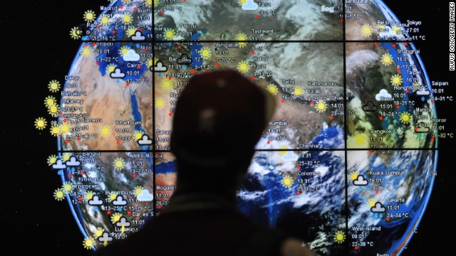 A passenger views a weather map in the departures terminal of Kuala Lumpur International Airport on Saturday, March 22.