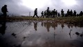 Russian soldiers patrol the area surrounding the Ukrainian military unit in Perevalnoye, outside Simferopol, on March 20, 2014.