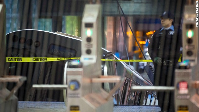 A police officer stands near the derailed train. The Chicago Transit Authority's Blue Line service was suspended between the O'Hare airport and the Rosemont stop after the derailment, a CNN affiliate reported.