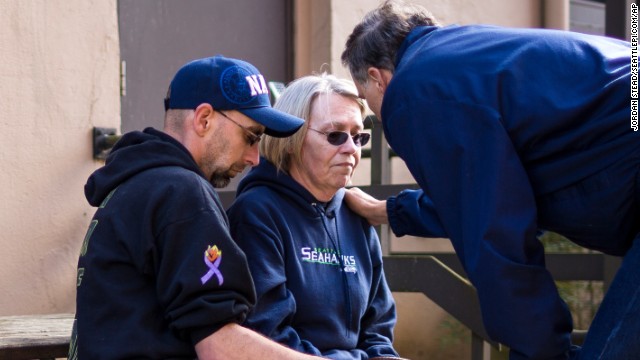 Gov. Jay Inslee, right, comforts Barbara Welsh after a news conference March 23 outside the Arlington Police Department. Welsh's husband, Bill, was among the scores of people listed as missing immediately after the disaster.