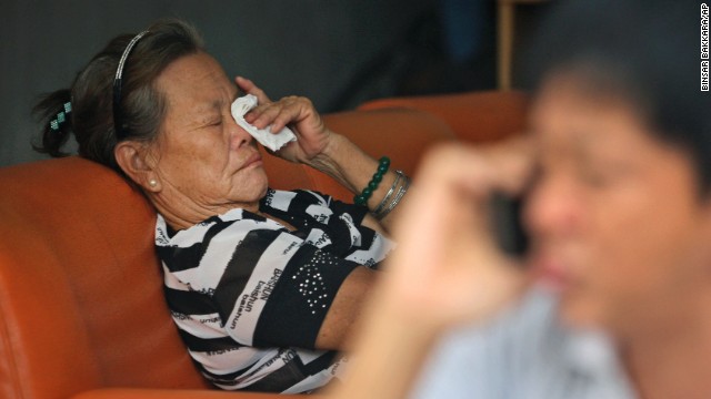 The mother of a passenger who was on Malaysia Airlines Flight 370 cries at her home in Medan, Indonesia, on March 25.