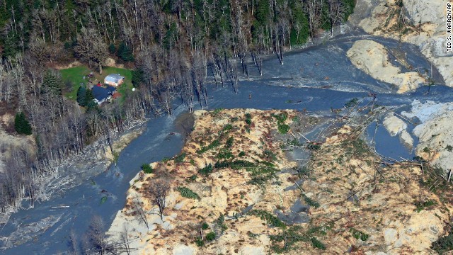 An intact house sits at the edge of the landslide on March 24.