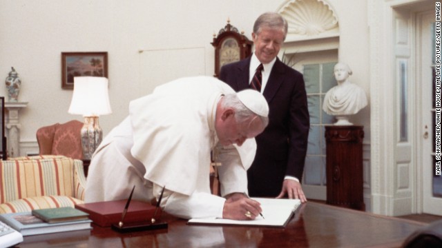 President Jimmy Carter watches Pope John Paul II sign the White House guest book in 1979. He was the first Pope to visit the White House.