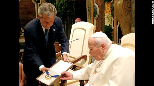 President George W. Bush presents Pope John Paul II with the Presidential Medal of Freedom at the Vatican in 2004. During their meeting, the Pope reminded Bush of the Vatican's strong opposition to the U.S.-led invasion of Iraq.