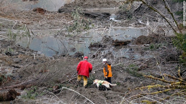 Search-and-rescue workers look through debris on March 26.