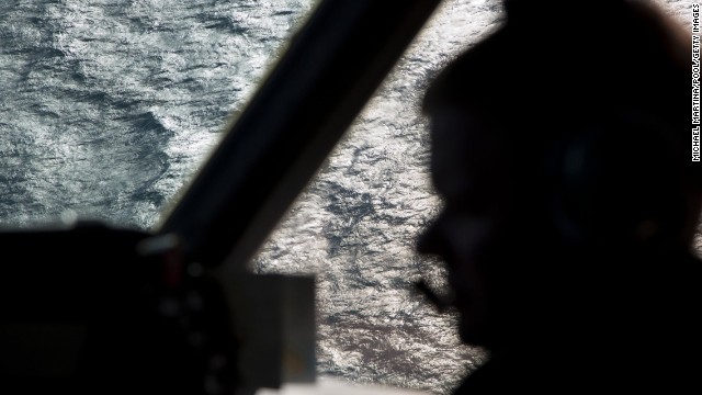 A member of the Royal Australian Air Force is silhouetted against the southern Indian Ocean during the search for the missing jet on Thursday, March 27.