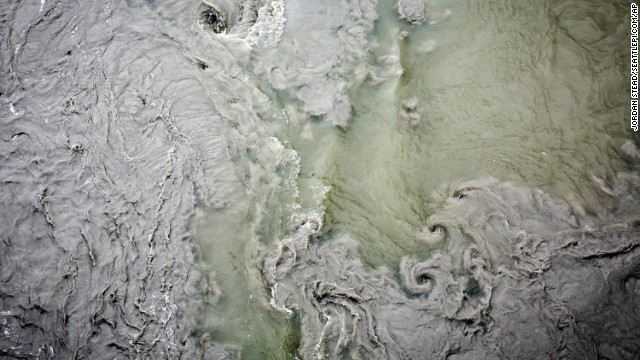 The muddied waters of the North Fork of the Stillaguamish River mix with the cleaner flow of the river's South Fork on March 27.