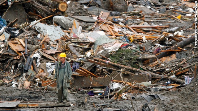 A searcher walks near a massive pile of debris in Oso on March 27.