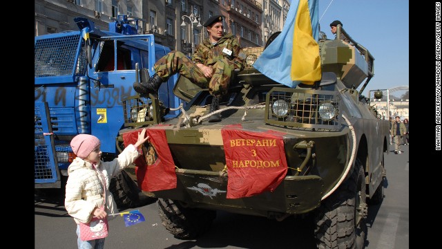 Demonstrators protest Friday, March 28, in Kiev, displaying police vehicles they seized during earlier clashes with authorities.