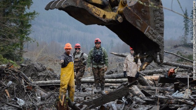 Heavy machinery is used to move debris as members of the Air National Guard search for victims on March 29. 