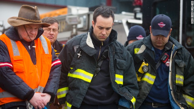 Search-and-rescue personnel attend a moment of silence at the fire house in Darrington.