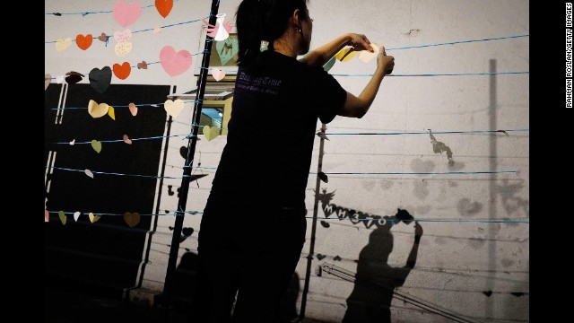 A woman prepares for an event in honor of those aboard Flight 370 on Sunday, March 30, in Kuala Lumpur, Malaysia.