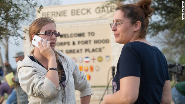 Krystina Cassidy and Dianna Simpson, waiting outside the Bernie Beck Gate at Fort Hood, try to contact their husbands, who are stationed at the post.