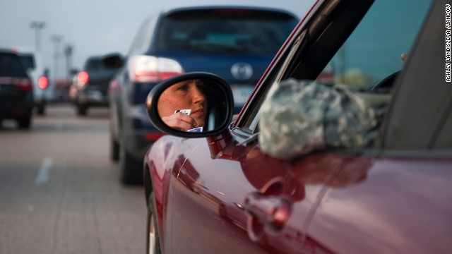 Lt. Savanah Hess, a nurse, waits in her car to enter the locked-down post.