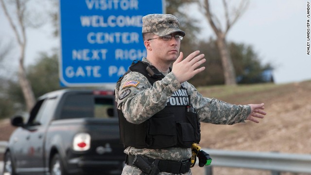 Military police direct traffic outside Fort Hood.