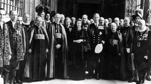 The Queen, then as Princess Elizabeth, poses for a group photo with her entourage, Vatican knights and Swiss Guards following a talk with Pope Pius XII in April 1951.