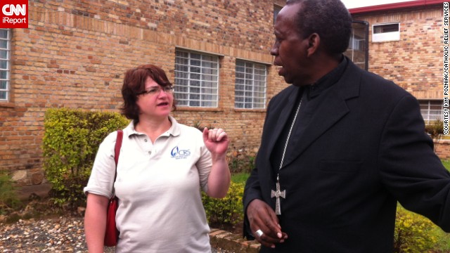 Leann Hager, Catholic Relief Services country representative in Rwanda until 2014, speaks with a local bishop about working together to reconcile communities after the genocide.