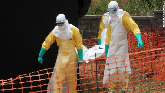 Members of Doctors Without Borders carry a dead body in Gueckedou on Friday, April 1. 