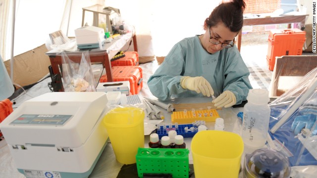 A health specialist works Monday, March 31, in a tent laboratory set up at a Doctors Without Borders facility in southern Guinea.