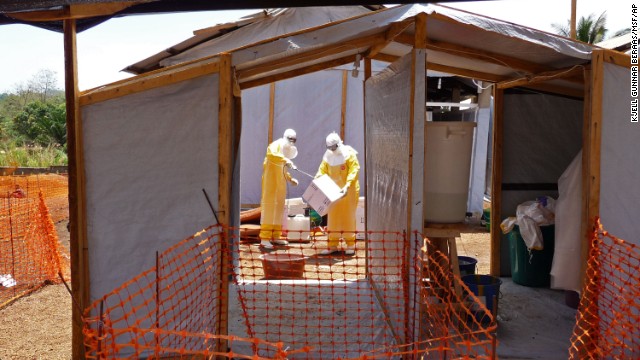 Workers associated with Medecins sans Frontieres prepare isolation and treatment areas Friday, March 28, in Guinea. 