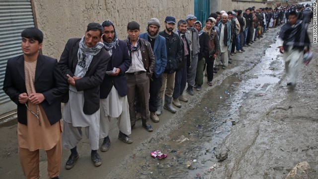 Men line up for registration before voting at a polling station in Kabul.