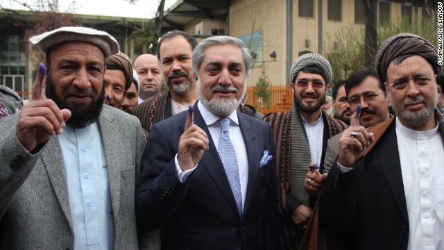 Presidential candidate Dr. Abdullah Abdullah, center, and his running mates Mohammed Mohaqiq, right, and Mohammad Khan, left, show their fingers marked with ink after casting their ballots at a polling station in Kabul.