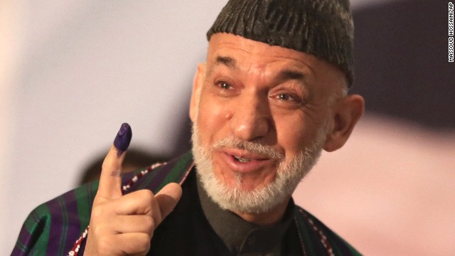 Afghan President Hamid Karzai displays his inked finger after voting. 