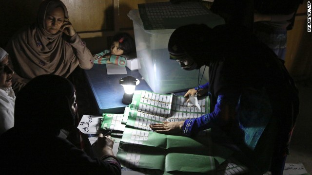 Afghan election workers count ballots by the light of a lantern at a polling station in Jalalabad, Afghanistan, on Saturday, April 5.