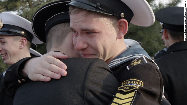 Ukrainian cadets at the Higher Naval School embrace a friend who has decided to stay in the school during a departure ceremony in Sevastopol, Crimea, on Friday, April 4. Some 120 cadets who refused to take Russian citizenship left the school to return to Ukraine.