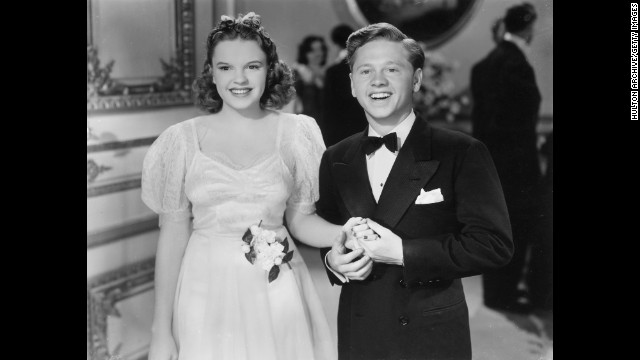 Rooney hold hands with Garland in a 1940 still from the film "Andy Hardy Meets Debutante."