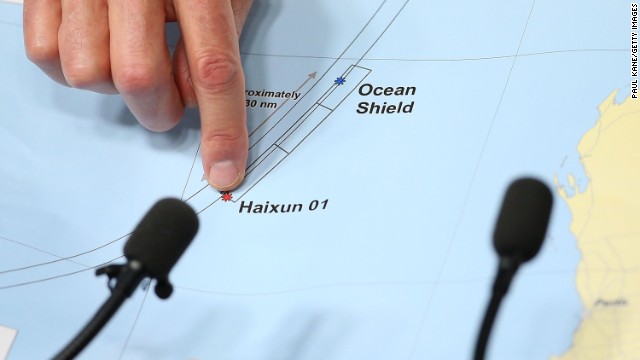 A member of the search operation points to a map outlining search areas during a news conference April 7 in Perth.