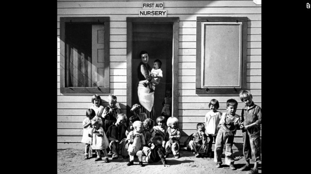A nurse takes care of children of migratory farm workers in Arvin, California, in 1937. The unemployment rate hovered in the teens. FDR created large-scale public work programs to provide jobs for the poor and middle class. 