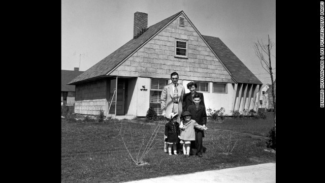 Truck supervisor Bernard Levey with his family in front of their new home in 1950. The post-war period was a prosperous time for middle-class Americans. 