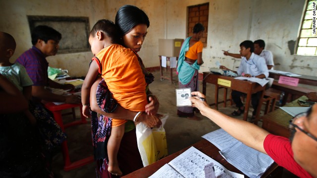 An official checks a voter's identity card in Agartala, India, on Monday, April 7. India's general election will be held in stages over five weeks. Voters will elect 543 members to the lower house of parliament, which will then select the country's next prime minister. Prime Minister Manmohan Singh is stepping aside after a decade in charge.