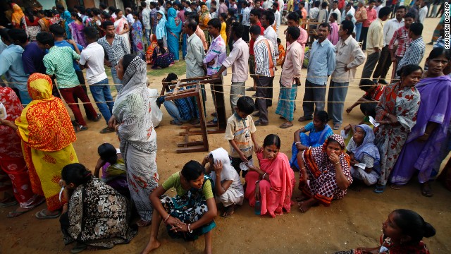 People wait in lines to cast their votes in Agartala on April 7.