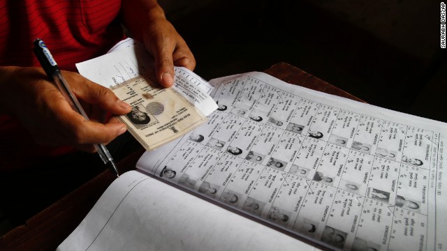 An election official checks the identity of a voter on April 7.